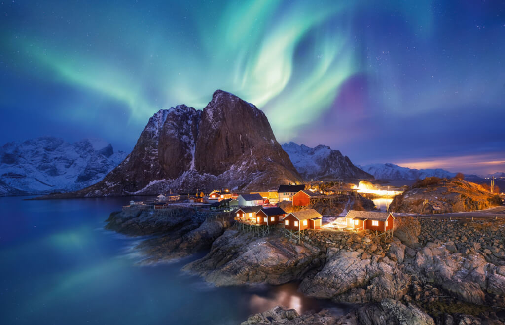 Aurora borealis on the Lofoten islands, Norway. Green northern lights above ocean. Night sky with polar lights. Night winter landscape with aurora and reflection on the water surface. Norway-image; Shutterstock ID 1314393140; purchase_order: Expi Vorschau 2023-2024; job: Expeditionsschiffe; client: Kim Lisa Klemp über Imke Lackmann / Westermann; other: 24708jk